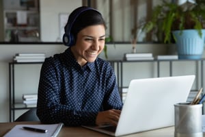 Woman smiling looking at computer